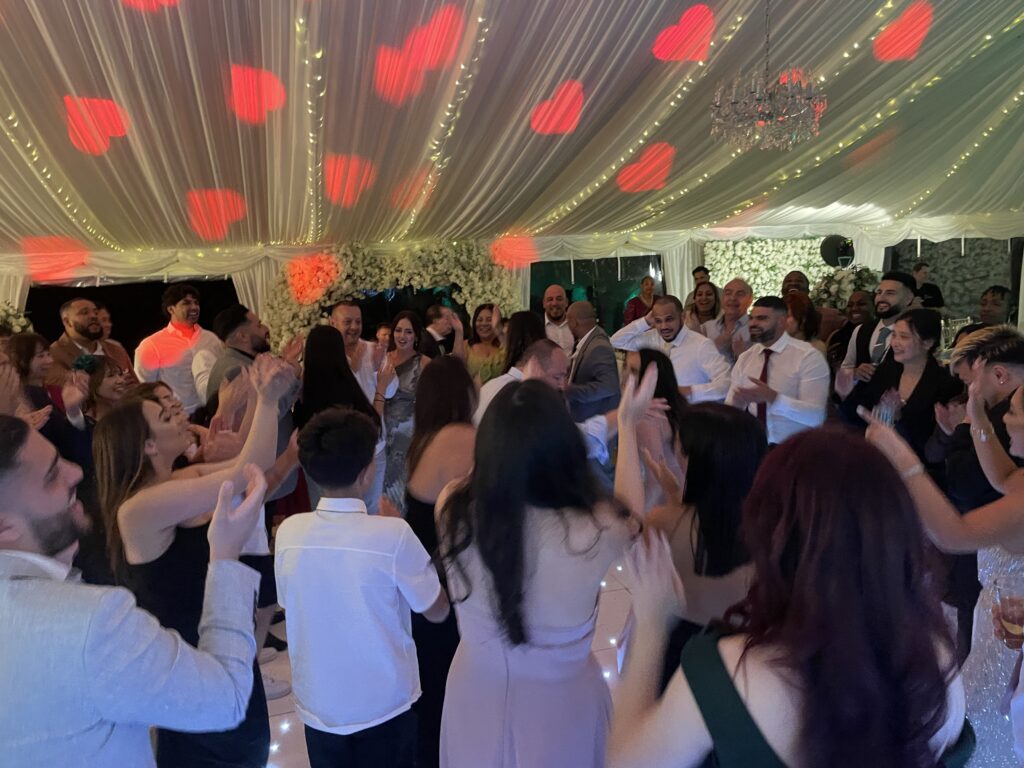 Hip hop wedding DJ playing 90s and 2000s classics on the dancefloor"