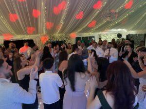Hip hop wedding DJ playing 90s and 2000s classics on the dancefloor"