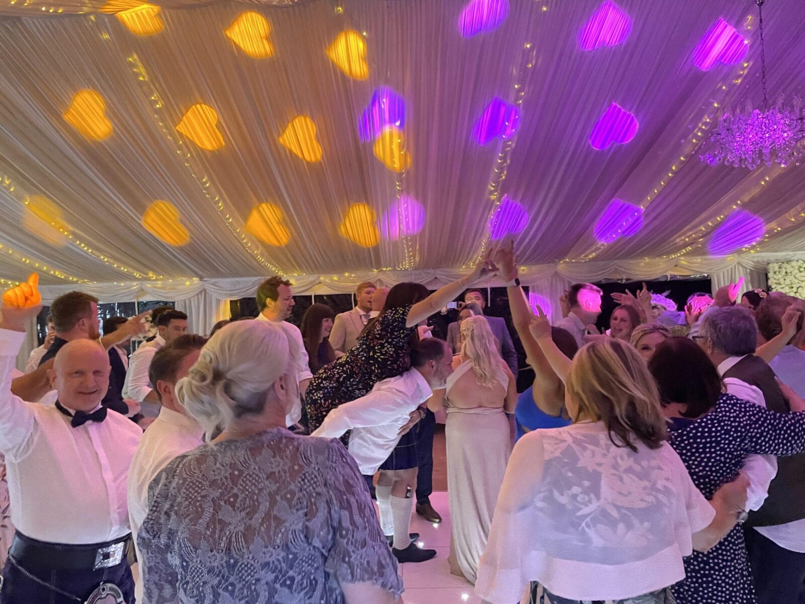 2010s pop wedding DJ creating fun and romantic dancefloor atmosphere