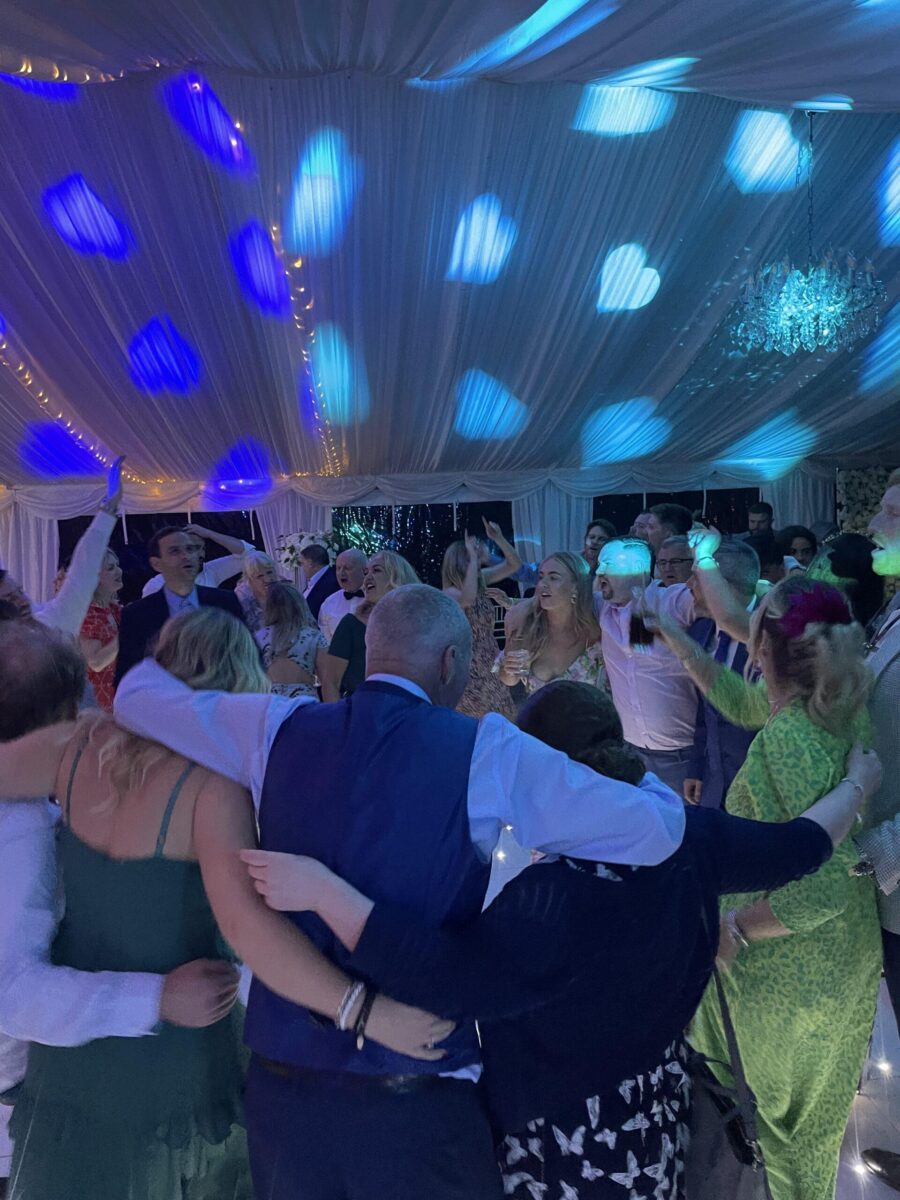 guests dancing under blue heart lights