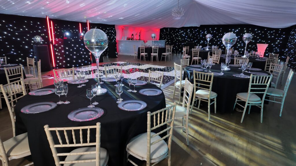 Platinum Wedding DJ Package black setup with LED lighting and mirror ball effects at wedding reception