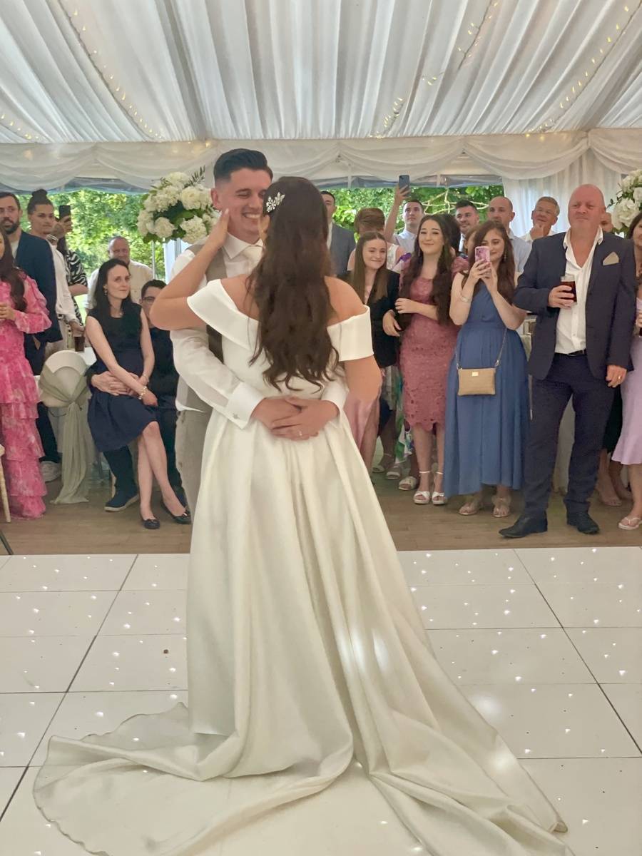 Bride and groom dancing under gentle lighting