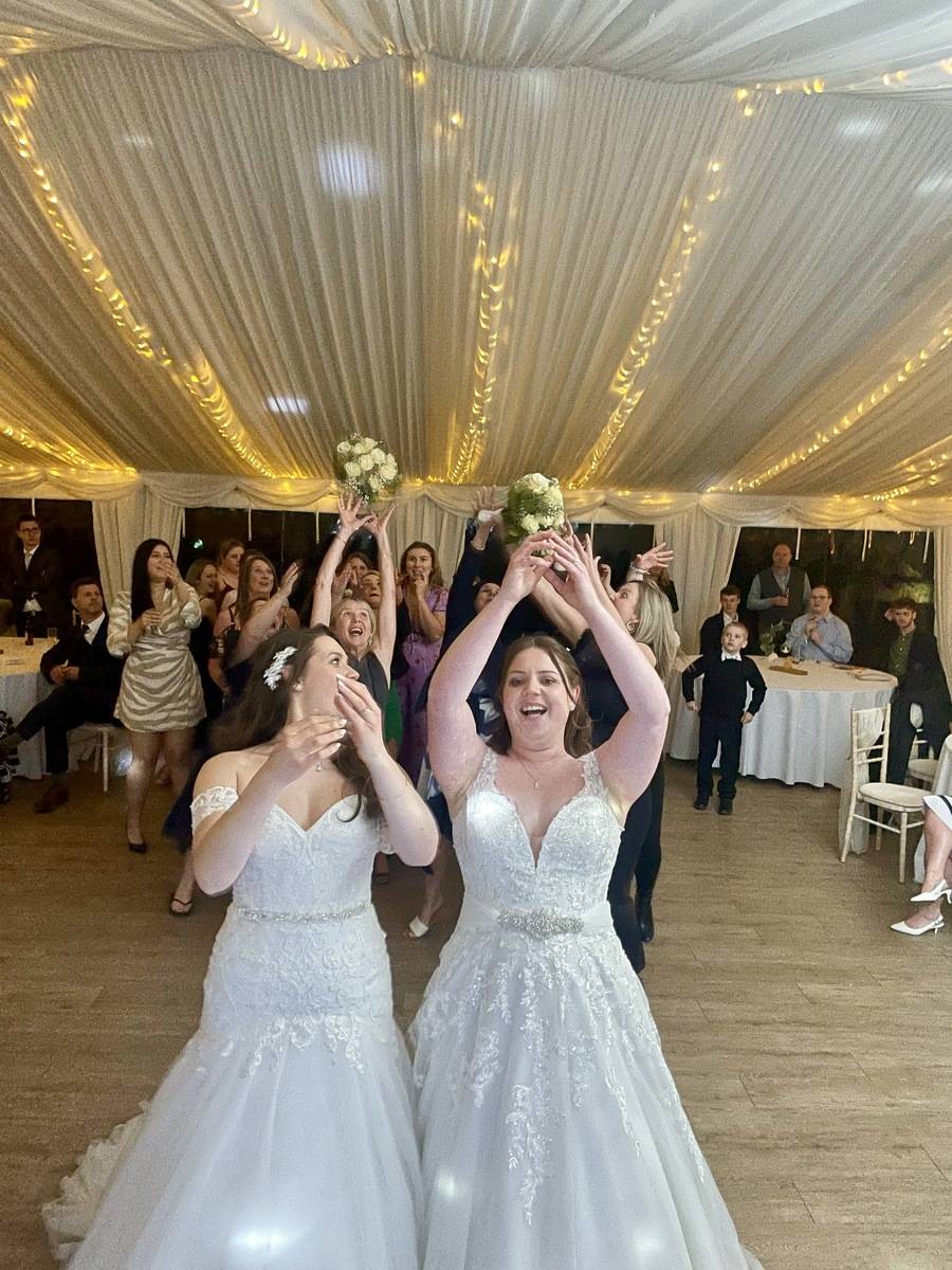 Brides about to throw the bouquet