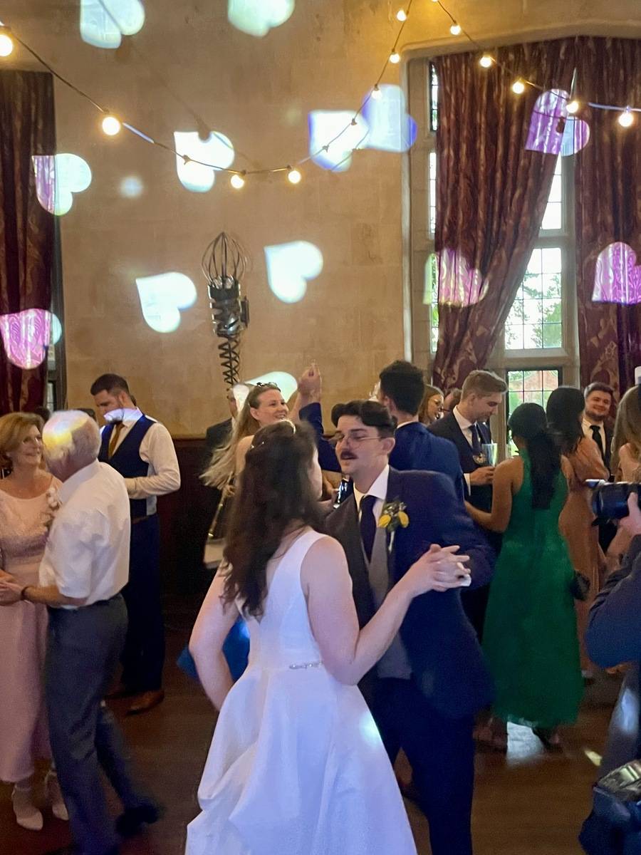 Bride and groom dancing under gentle lighting
