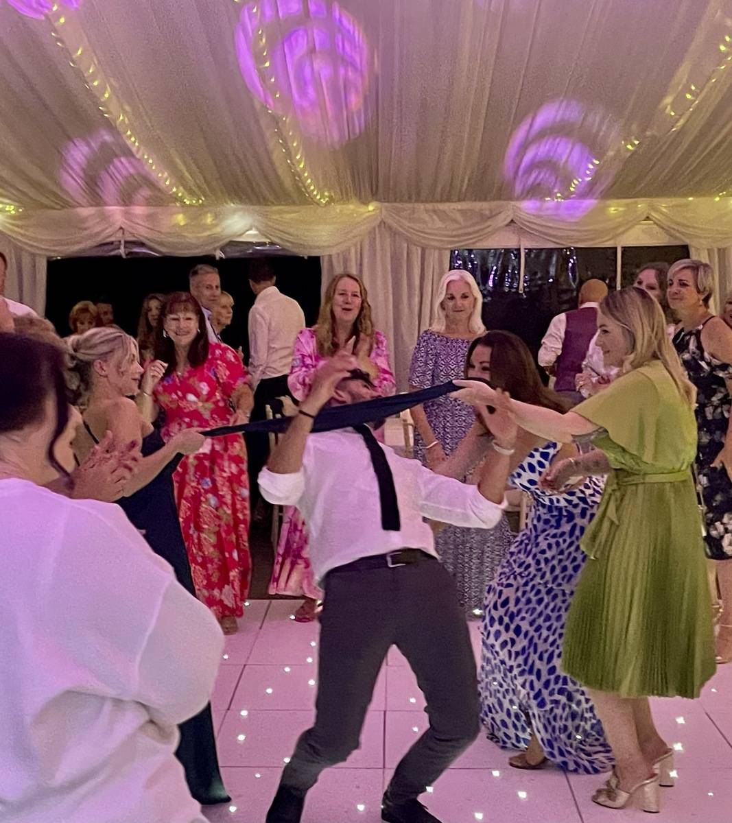 Guests doing the limbo at a wedding