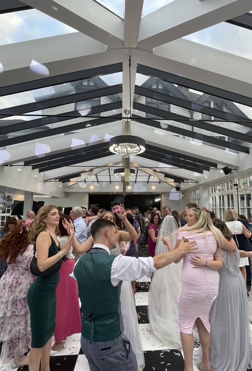 People dancing as the DJ takes the party higher